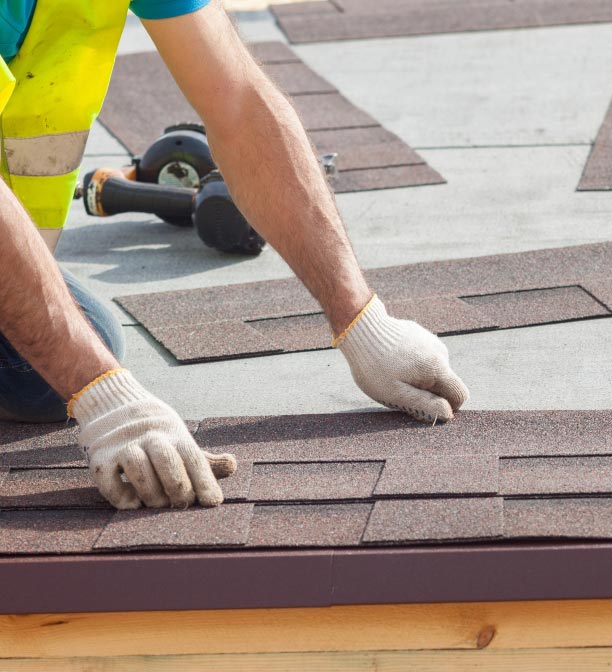 Roofer laying shingles